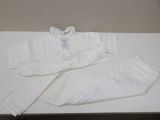 a pair of white pants and a white shirt on a table
