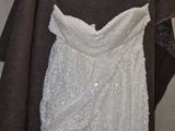 wedding dress hanging on a hanger in a room