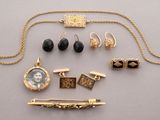 an assortment of jewelry including a necklace, earrings, and a broochle