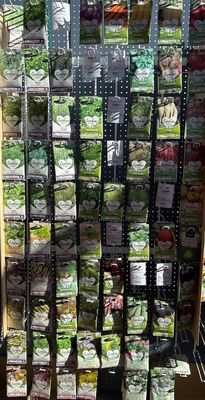many different types of vegetables on the shelves in the store