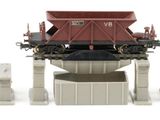 three toy trains sitting next to each other on a white surface