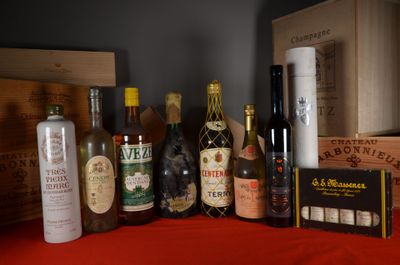 many bottles of wine and bottles of liquor on a table
