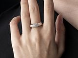 someone is wearing a ring that has a diamond on it