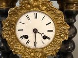 a black and gold clock with a gold frame on it