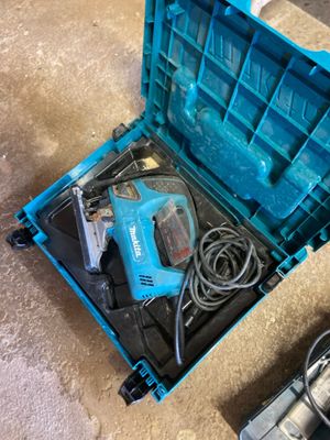 a blue tool box with tools inside of it on the floor