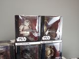 five star wars action figures in boxes on a table