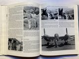 an open book with a picture of a man standing in front of an airplane