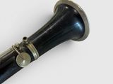 a black and silver trumpet on a white surface
