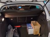 a trunk of a car with a bunch of boxes in it