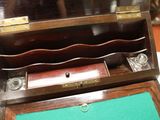 a small wooden box with a glass in it on a table