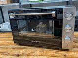 an image of a toaster oven sitting on a wooden table