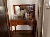 a wooden table with a mirror and a vase on it