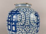 un vase bleu et blanc posé sur une table