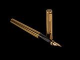 a close up of a fountain pen and a pen tip on a black background