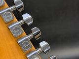 a close up of the headstocks on an electric guitar