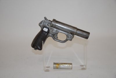 a small gun that is on display on a clear stand