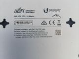 the back of a white wii game console sitting on top of a table