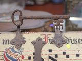 an old suitcase with a key on it sitting on a table