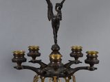 an antique bronze candelabra with angels and candles