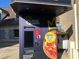 a vending machine that has a pizza on the front of it