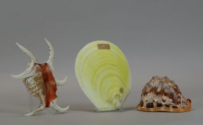 three figurines of different shapes and sizes on a table