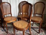 three chairs and a table in a room with a rug on the floor
