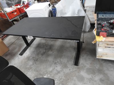 a black desk with a black chair in a room