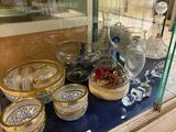 a glass display case with a lot of glass items on it