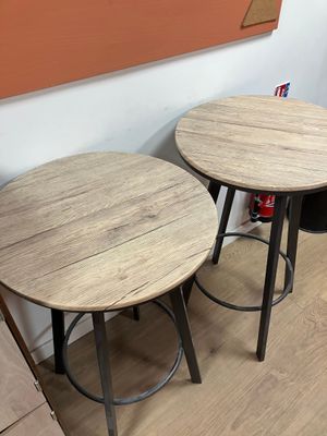 two tables that are sitting next to each other on the floor