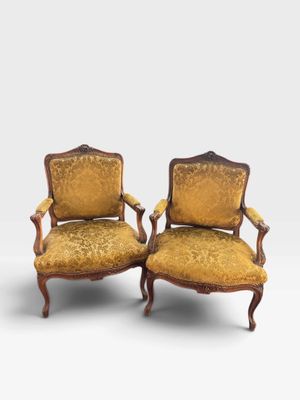 pair of antique chairs with upholstered upholstered arms
