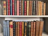 many old books on a shelf in a book case