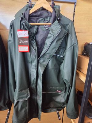 a green jacket hanging on a rack in a clothing store