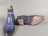 pair of men ' s blue leather shoes on a gray surface