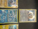 a lot of different pokemon cards on the table