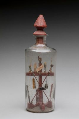 a glass bottle with a picture inside of it
