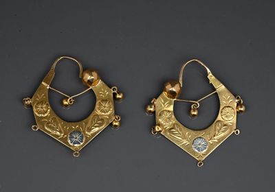 pair of gold earrings with blue stones and pearls