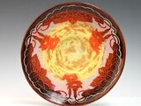 an image of a red and yellow plate with a design on it