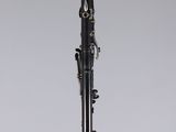 a black and silver clarinet on a white surface