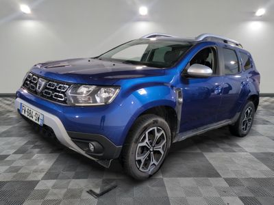 the blue dacia is parked on a checkered floor