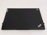 the back of a laptop with a black cover on a white surface