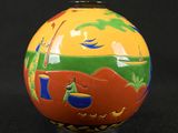a small vase with a painting on it on a black background