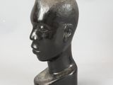 sculpture of a man ' s head on a marble base
