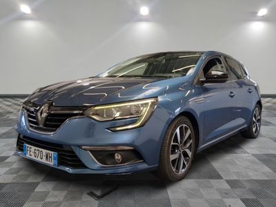 a blue car is parked on a checkered floor in a garage