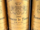 three bottles of wine are lined up on a table