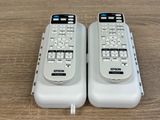 two remote controls that are sitting on a table