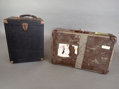 two old suitcases sitting next to each other on a table