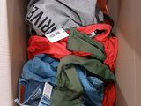 a cardboard box filled with clothes and a tag