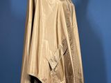 an image of a cape on a mannequin stand against a blue background