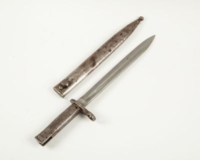 an old knife and a small knife on a white surface
