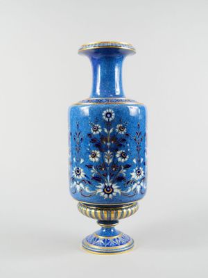 a blue vase that is sitting on a table